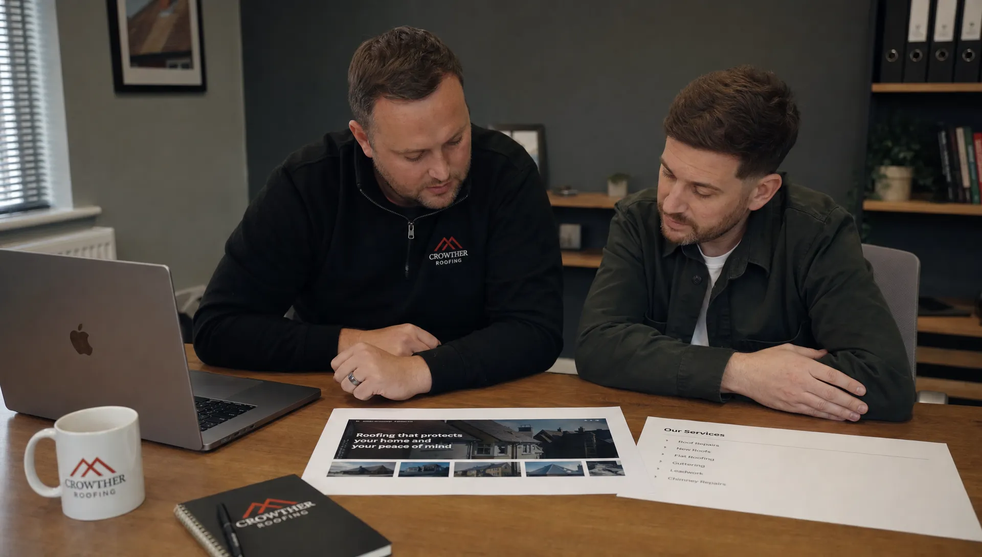 A business owner and an SEO specialist review a homepage layout and service list at a table.